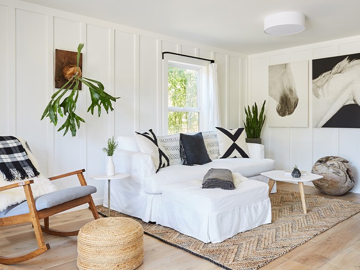 Bright, naturally lit living room with white walls and sofa.